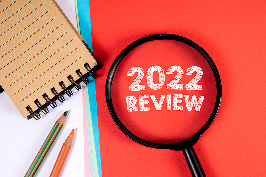 2022 Review. Magnifying glass on a red background