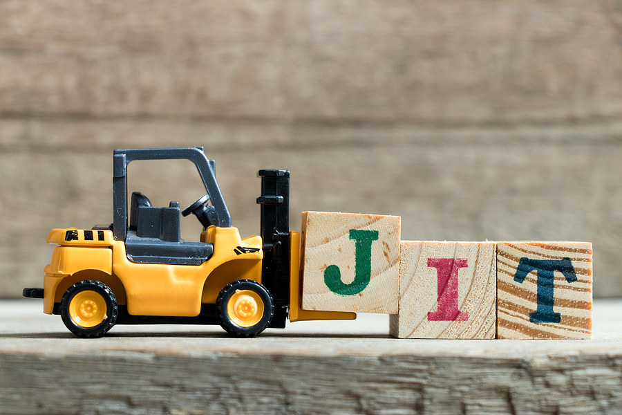 Toy yellow forklift holding letter block J to complete word JIT (Abbreviation of Just in time) on wood background – JIT Inventory Management