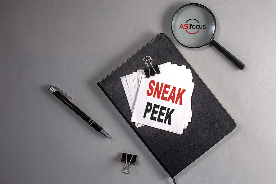 notebook with note on top saying "sneak peek" with magnifying glass next to it