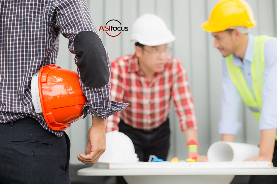 several people standing at a construction site discussing plans