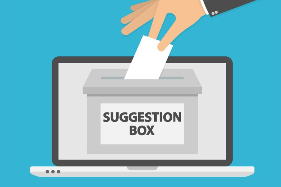 hand dropping a suggestion into a suggestion box for Sage 100 2026