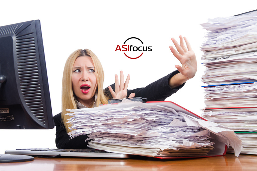 woman fending off growing stacks of paperwork